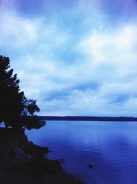 Scenic view of calm sea against cloudy sky