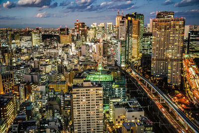 High angle view of illuminated buildings in city against sky