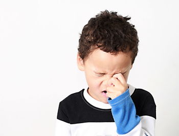 Portrait of boy looking away against white background stock photo