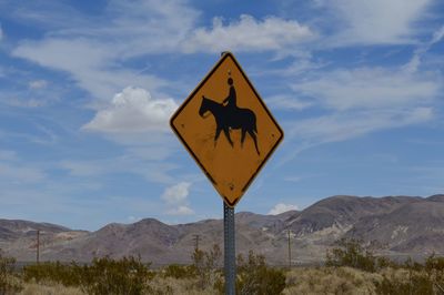 Road sign against blue sky