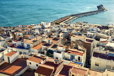 High angle view of townscape by sea