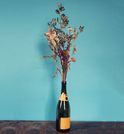 Close-up of flower vase on table against clear sky