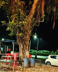 Table by illuminated street at night