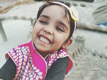 High angle portrait of smiling girl standing outdoors