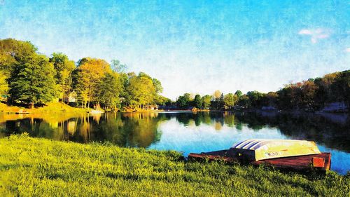 Scenic view of calm lake against clear blue sky