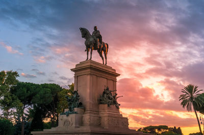 Low angle view of statue against sky during sunset