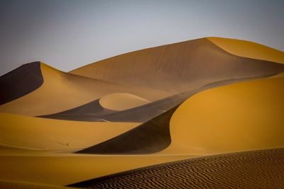 Scenic view of desert against clear sky