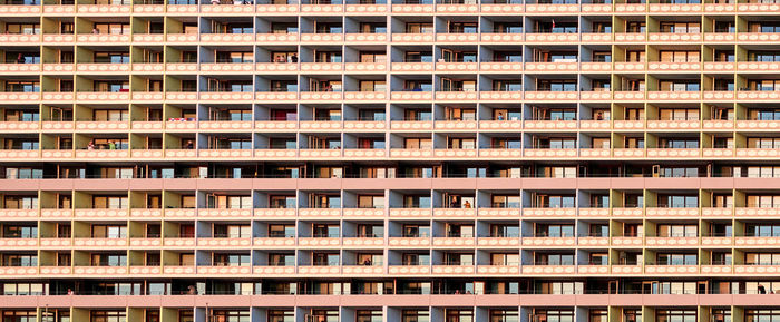 Frontal view of a large monotonous skyscraper with small vacation apartments for visitors of sylt