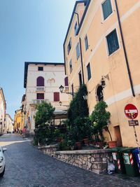 Street amidst buildings against sky