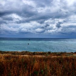 Scenic view of sea against cloudy sky