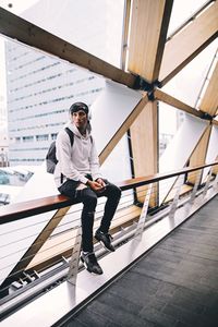 Full length of woman standing by railing