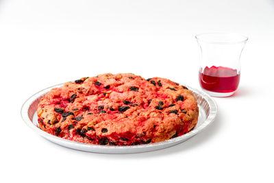 Close-up of pizza on table against white background