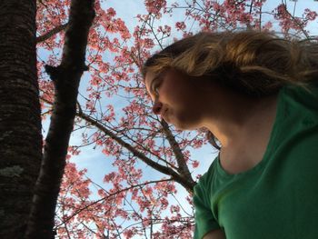 Woman against cherry blossom tree