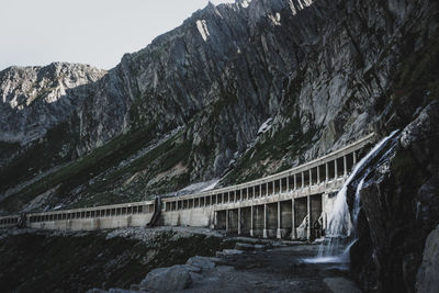 Bridge over mountains against sky