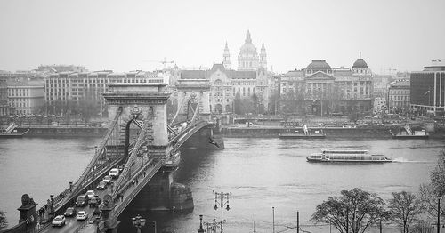 Boats in river with buildings in background