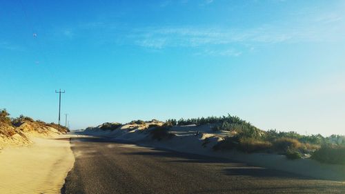 Scenic view of landscape against blue sky