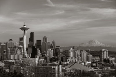 View of cityscape against cloudy sky