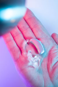 Close-up of hand holding pink water