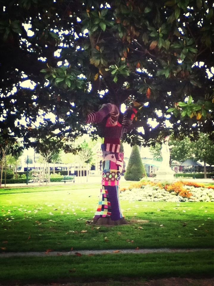 tree, human representation, statue, sculpture, grass, park - man made space, art, art and craft, green color, creativity, growth, lawn, day, sunlight, park, outdoors, fountain, formal garden