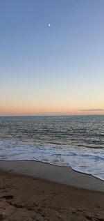 Scenic view of sea against clear sky during sunset