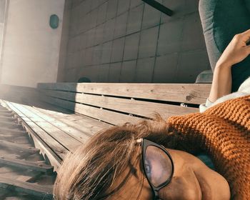 Rear view of woman resting on floor