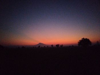 Scenic view of silhouette landscape against clear sky during sunset