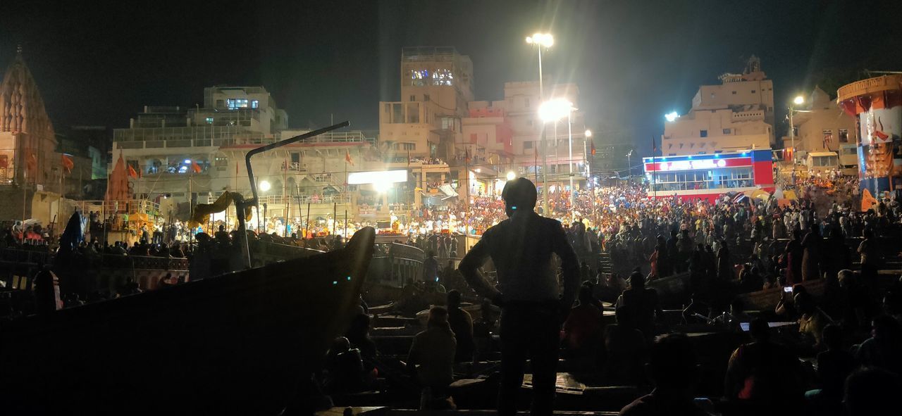 GROUP OF PEOPLE ON STREET AT NIGHT