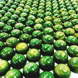 Full frame shot of green bowls arranged on table