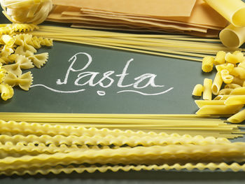 Close-up of raw pastas and text on black background
