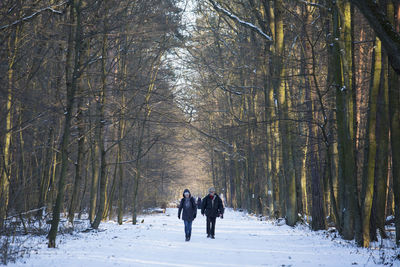 People walking on snow covered landscape