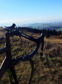 Bicycle on field against sky