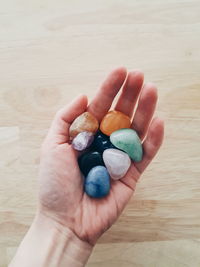 High angle view of hand holding food on table