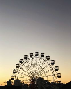 Low angle view of ferris wheel against sky