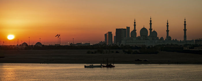 Scenic view of buildings against sky during sunset