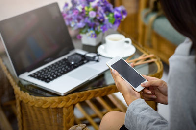 Midsection of woman using mobile phone