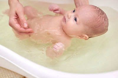 Baby taking bath in bathtub