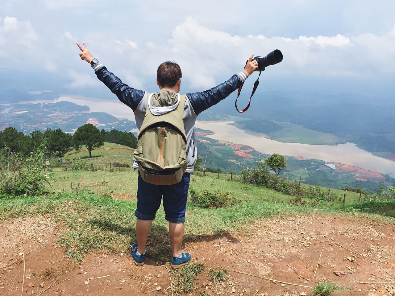 sky, leisure activity, full length, lifestyles, casual clothing, mountain, cloud - sky, standing, tranquil scene, rear view, tranquility, scenics, landscape, men, nature, beauty in nature, cloud, vacations