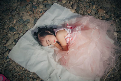 High angle view of woman lying down on bed