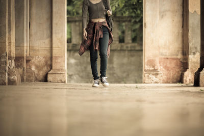 Low section of woman walking on zebra crossing