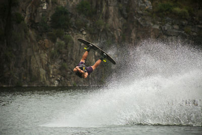Man jumping at wakeboard park - extreme sport shot.