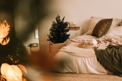 Portrait of woman sitting on bed at home