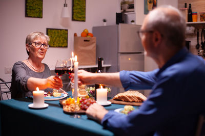 Portrait of woman holding christmas presents at home