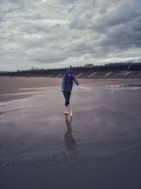 Full length of teenage girl standing on beach