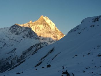 Scenic view of snowcapped mountains against clear sky