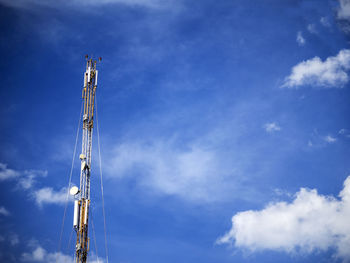 Gsm antenna on a blue sky with clouds