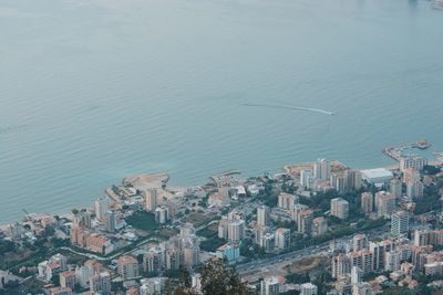 High angle view of buildings by sea against sky