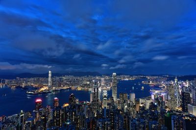 Illuminated cityscape against sky at night