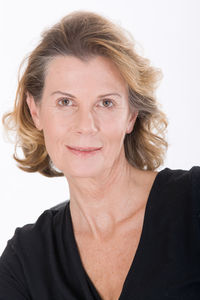 Close-up portrait of smiling woman over white background