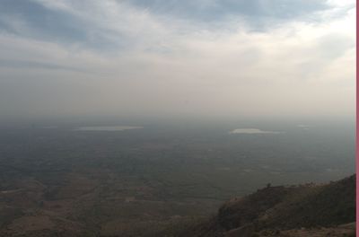 Aerial view of landscape against cloudy sky