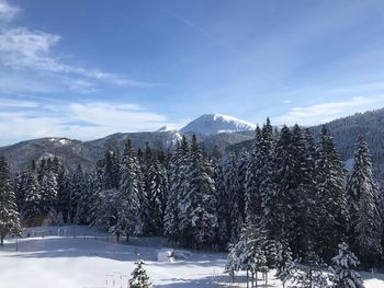 Scenic view of snow covered mountains against sky